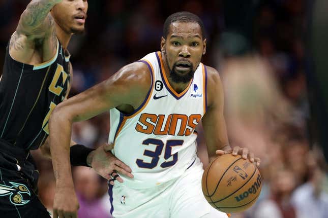 Mar 1, 2023; Charlotte, North Carolina, USA; Phoenix Suns forward Kevin Durant (35) drives to the basket past Charlotte Hornets guard Kelly Oubre Jr. (12) during the second half at Spectrum Center.