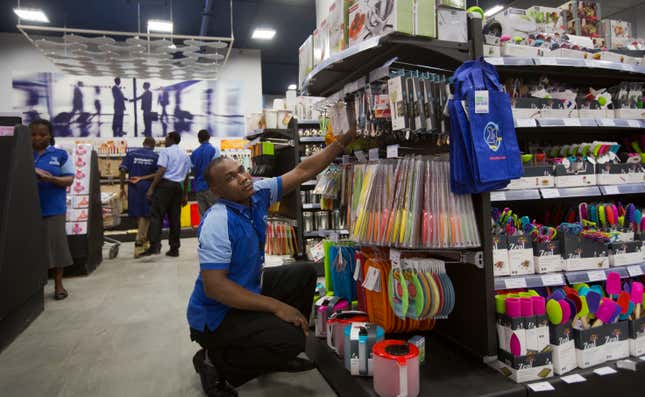 Employees of the supermarket chain Nakumatt stock shelves
