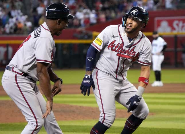 Jun 4, 2023; Phoenix, AZ, USA; Atlanta Braves' Eddie Rosario (8) celebrates his ninth inning grand slam with third base coach Ron Washington (37) against the Arizona Diamondbacks at Chase Field.