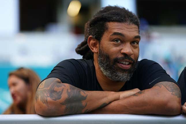 Nov 28, 2021; Miami Gardens, Florida, USA;  Carolina Panthers former defensive end Julius Peppers sits in the stands prior to the game between the Miami Dolphins and the Carolina Panthers at Hard Rock Stadium.