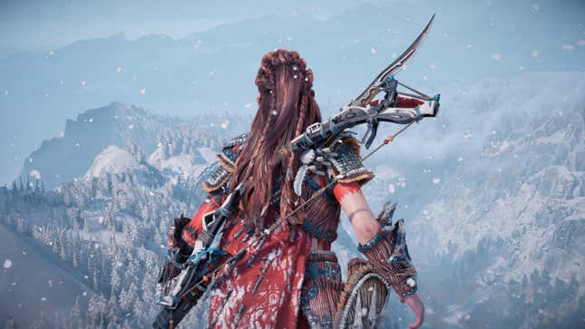 Aloy stares out at a snowy wilderness from a mountaintop in Horizon Forbidden West, one of the best games on PS5.