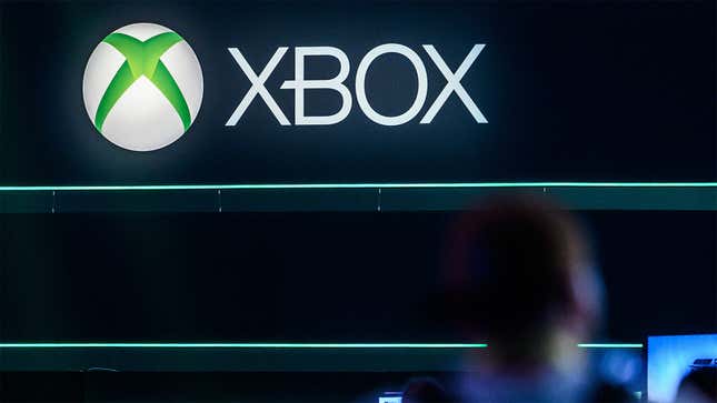 An Xbox logo hangs overhead at a trade event.