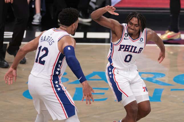 Apr 22, 2023; Brooklyn, New York, USA; Philadelphia 76ers guard Tyrese Maxey (0) celebrates with forward Tobias Harris (12) after a basket against the Brooklyn Nets during the second half of game four of the 2023 NBA playoffs at Barclays Center.