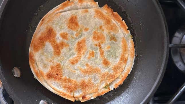 This scallion pancake is finished, and the pan should get re-oiled before the next one goes in.