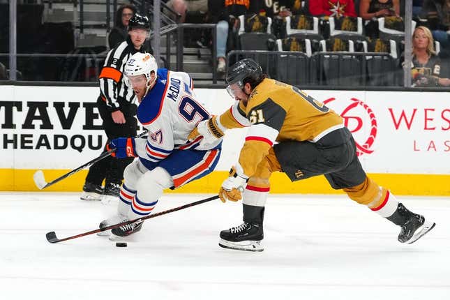May 3, 2023; Las Vegas, Nevada, USA; Vegas Golden Knights right wing Mark Stone (61) protects the puck from the stick of Edmonton Oilers center Connor McDavid (97) during the first period of game one of the second round of the 2023 Stanley Cup Playoffs at T-Mobile Arena.
