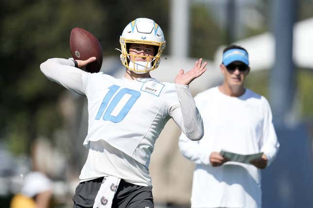 Jul 26, 2023; Costa Mesa, CA, USA; Los Angeles Chargers quarterback Justin Herbert (10) throws the ball as quarterbacks coach Doug Nussmeier watches during training camp at Jack Hammett Sports Complex.Image: Kirby Lee-USA TODAY Sports