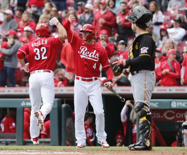 Apr 2, 2023; Cincinnati, Ohio, USA; Cincinnati Reds first  baseman Jason Vosler (32) reacts with designated hitter Wil Myers (4) after hitting a solo home run against the Pittsburgh Pirates during the second inning at Great American Ball Park.