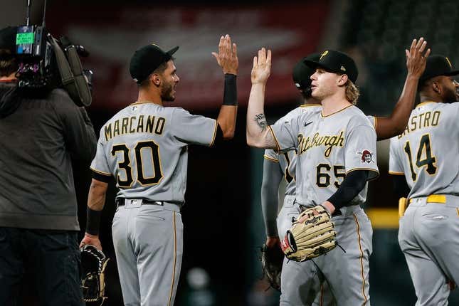 Apr 18, 2023; Denver, Colorado, USA; Pittsburgh Pirates center fielder Jack Suwinski (65) celebrates with second baseman Tucupita Marcano (30) after the game against the Colorado Rockies at Coors Field.