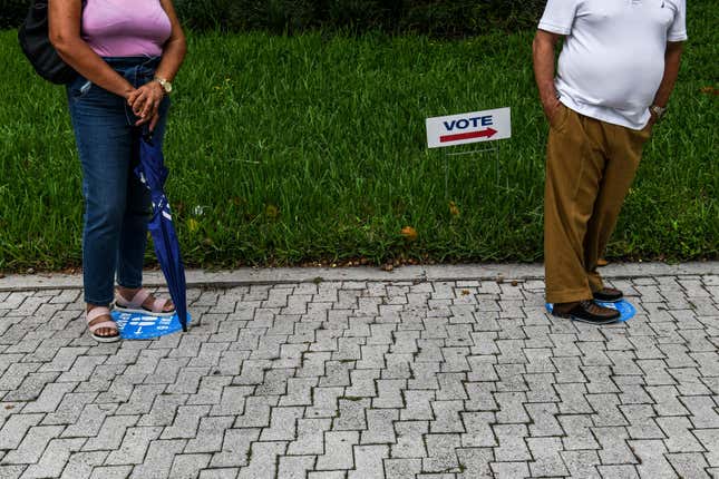 Voters wait in line to cast their early ballots at Miami Beach City Hall in Miami Beach, Florida on October 20, 2020. 