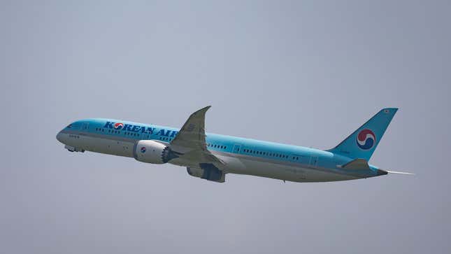 A photo of a Korean Air plane flying in the sky. 