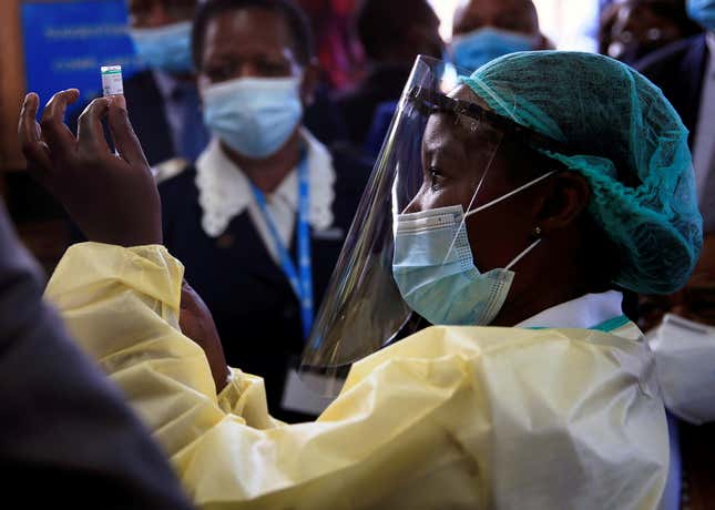A nurse prepares to vaccinate Zimbabwean vice-president Constantino Chiwenga as the country begins vaccinations against Covid-19 on Feb. 18.