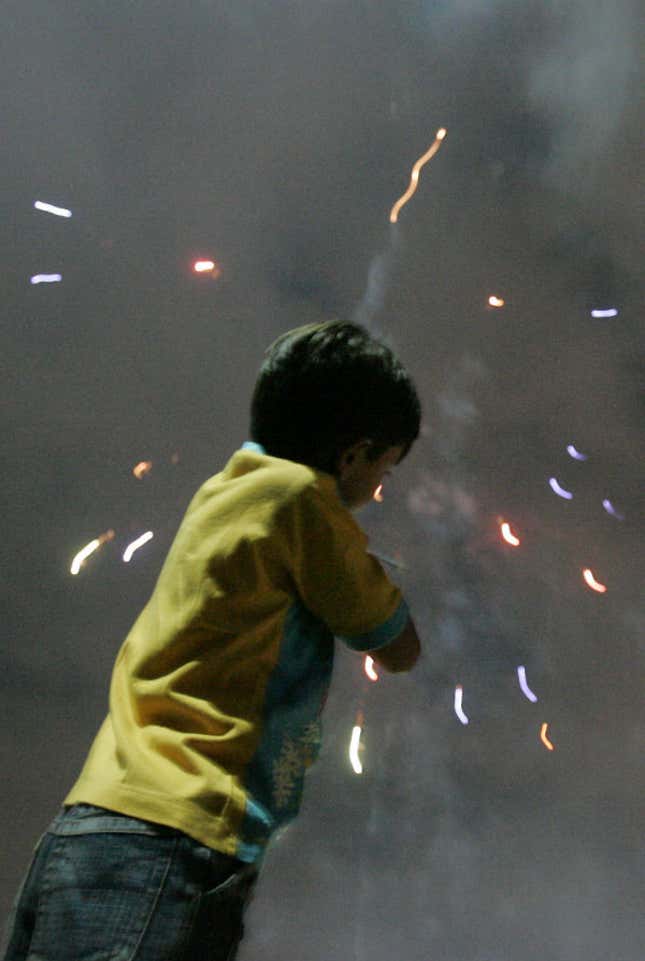 A boy in downtown Nairobi watches Diwali fireworks in 2007—back when they made noise.