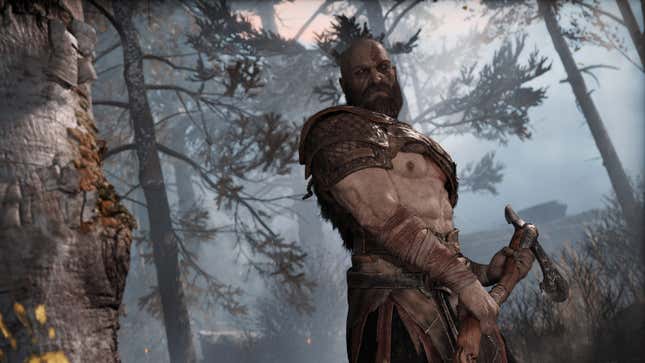 Kratos readies an axe to swing it at a tree in God of War on PC.