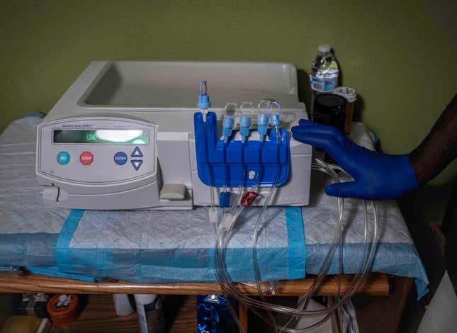 Bernard Zachery, 51, at home in Modesto, California, goes to bed each night hooked up to a peritoneal kidney dialysis machine that he sets up himself. Zacary spends about an hour each evening before bed prepping the machine, weighing, logging his weight and vitals and attaching the machine to a n abdominal catheter before settling in to watch a movie or read on his phone.