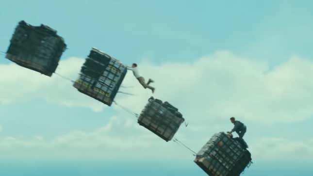 Nathan Drake holds onto a cargo box that's failing out of an airplane in the Uncharted movie.