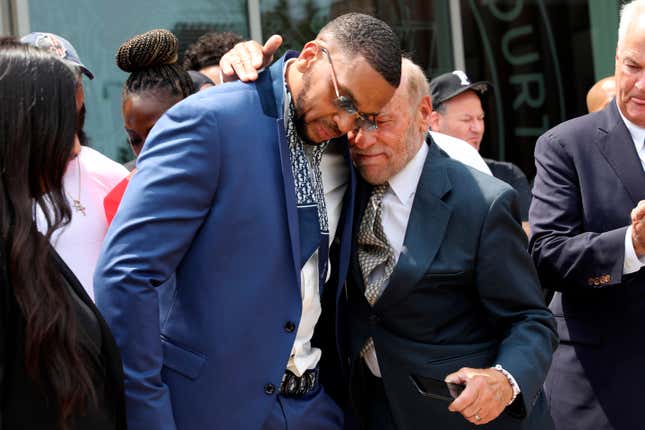 Grant Williams, left center, is embraced by his attorney Irving Cohen after his murder conviction is vacated, July 22, 2021, in New York. New York City has agreed to pay $7 million to Williams who spent 23 years behind bars for a murder he didn’t commit, Comptroller Brad Lander said Monday, May 23, 2022.