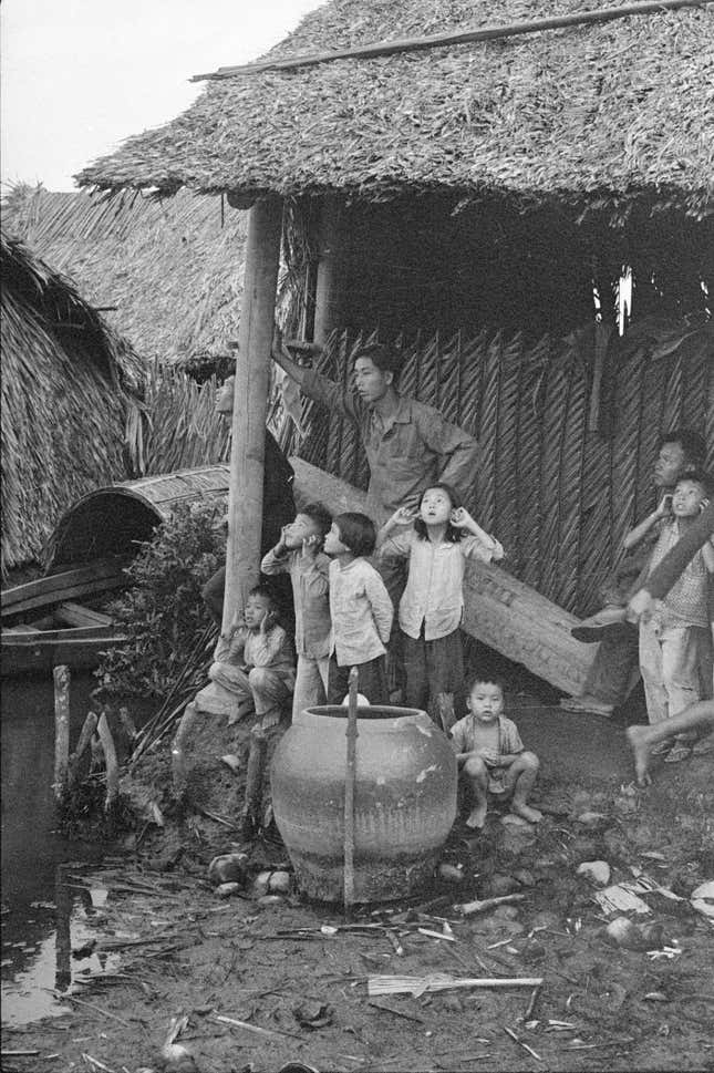 Vietnamese children respond to mortar fire, ca. 1961–62. This image originally appeared in National Geographic in 1962.