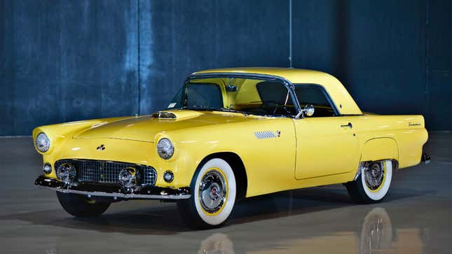 A photo of a yellow, 1955 Ford Thunderbird coupe. 
