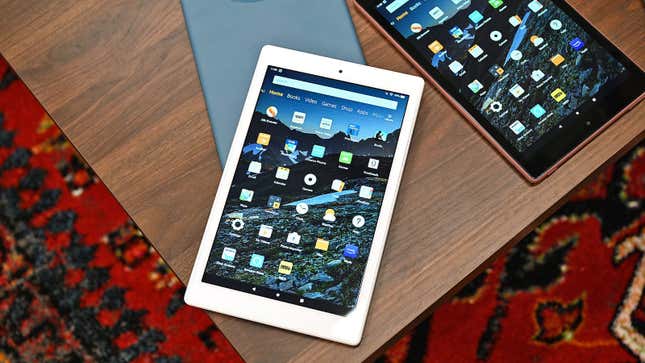 The Amazon Fire HD 10 tablet sitting on a wooden coffee table with other color variants.