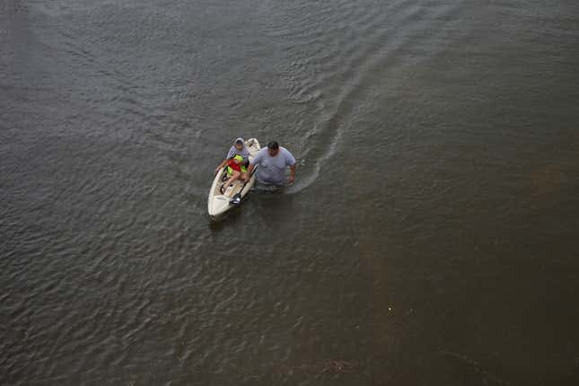 Jesus Rodriguez rescues Gloria Garcia after rain from Hurricane Harvey flooded Pearland, in the outskirts of Houston on Aug. 27.