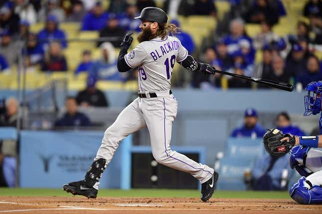 Apr 3, 2023; Los Angeles, California, USA; Colorado Rockies designated hitter Charlie Blackmon (19) reaches first on a fielders choice against the Los Angeles Dodgers during the first inning at Dodger Stadium.