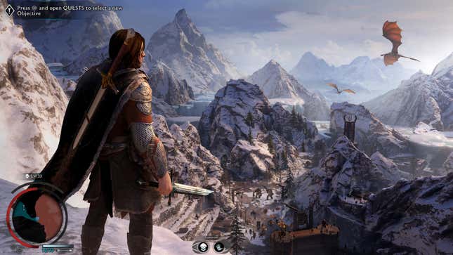 The main character of Mordor: Shadow of War looks out at snowy mountains while weilding a broken sword.