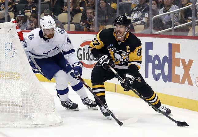 Feb 26, 2023; Pittsburgh, Pennsylvania, USA;  Pittsburgh Penguins center Sidney Crosby (87) moves the puck against Tampa Bay Lightning defenseman Nick Perbix (48) during the third period at PPG Paints Arena. The Penguins won 7-3.