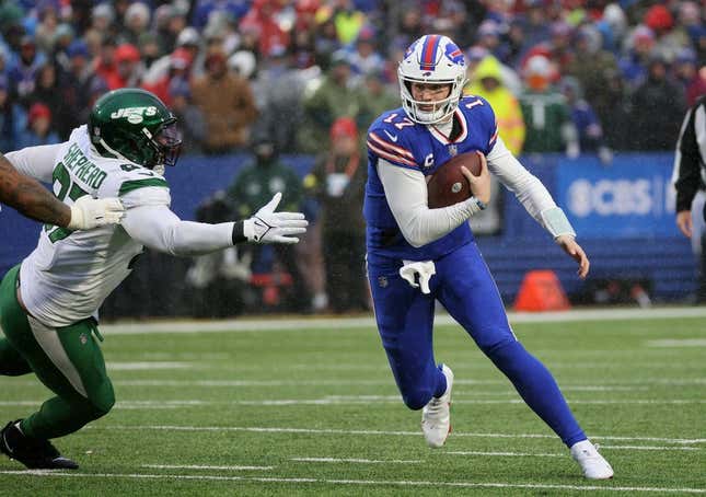 Bills quarterback Josh Allen avoids the tackle by Jets Nathan Shepherd.