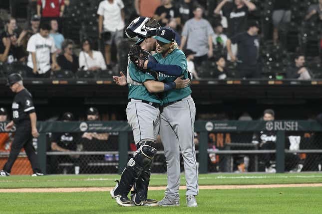 Aug 21, 2023; Chicago, Illinois, USA;  Seattle Mariners catcher Brian O&#39;Keefe (64) and Seattle Mariners relief pitcher Darren McCaughan (26) after the game against the Chicago White Sox at Guaranteed Rate Field.