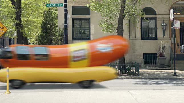 Image for article titled Mysterious Figure Impossibly Disappears Behind Passing Wienermobile