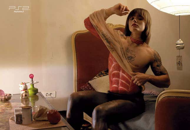 A woman pulls off a skin-colored shirt to reveal red muscle in this PS2 ad.