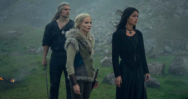 Henry Cavill as Geralt, Freya Allen as Ciri, and Anya Chalotra as Yennefer in The Witcher, staring at something off-screen that shocks them.