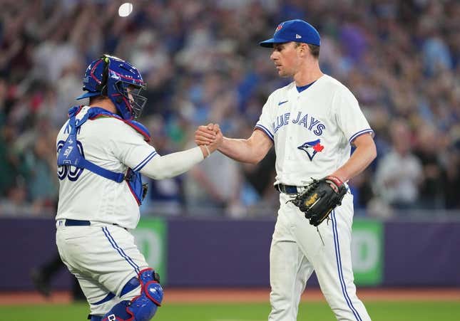 May 12, 2023; Toronto, Ontario, CAN; Toronto Blue Jays starting pitcher Chris Bassitt (40) celebrates a complete game win with Toronto Blue Jays catcher Alejandro Kirk (30) against the Atlanta Braves at the end of the  the ninth inning at Rogers Centre.