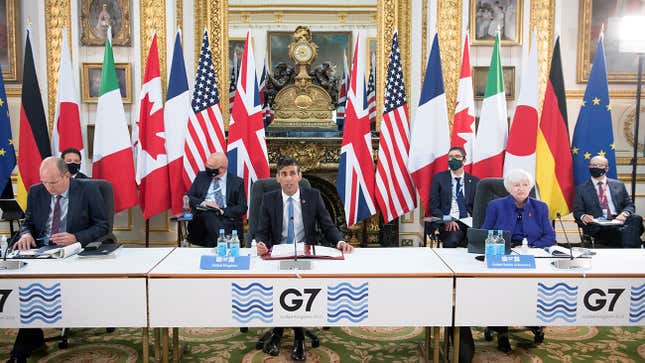 G7 Finance Ministers sit at tables with flags behind them in London