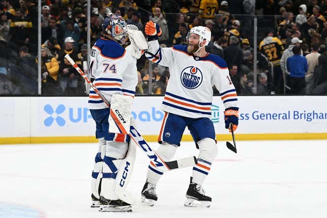 Mar 9, 2023; Boston, Massachusetts, USA; Edmonton Oilers defenseman Mattias Ekholm (14) celebrates with goaltender Stuart Skinner (74) after defeating the Boston Bruins at the TD Garden.