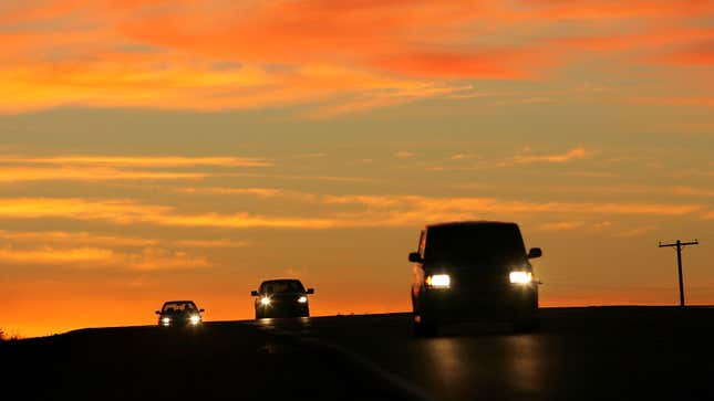 A photo of cars driving on a highway at sunrise in Arizona. 