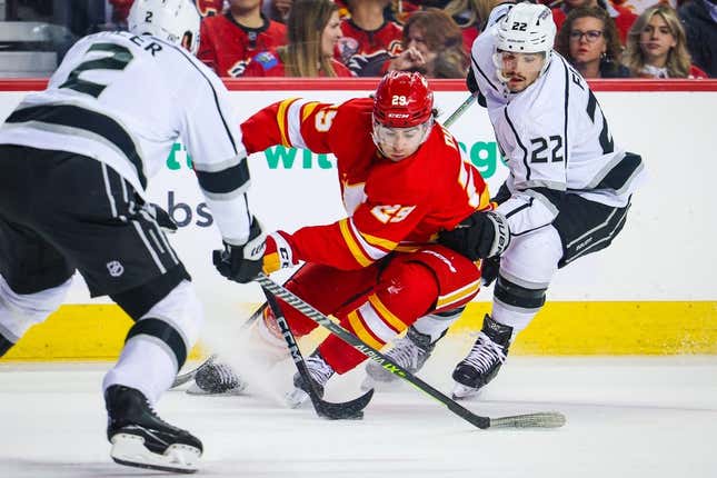 Mar 28, 2023; Calgary, Alberta, CAN; Calgary Flames center Dillon Dube (29) and Los Angeles Kings left wing Kevin Fiala (22) battle for the puck during the second period at Scotiabank Saddledome.
