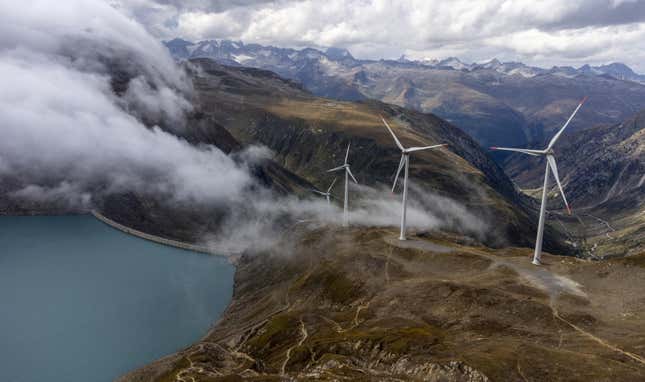 Windmills are seen in front of the Gries dam at SwissWinds farm, Europe's highest wind farm 