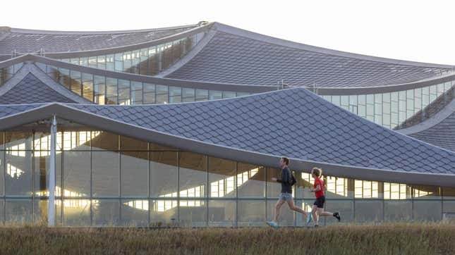 Two runners pass by the Bay View campus.