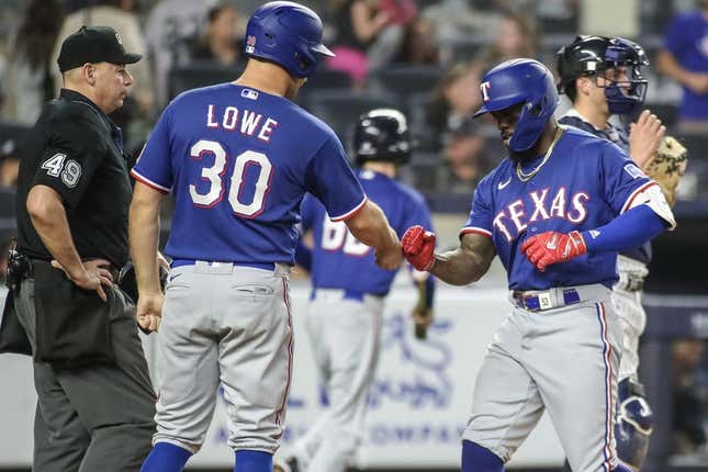 Jun 23, 2023; Bronx, New York, USA;  Texas Rangers right fielder Adolis Garcia (53) celebrates with first baseman Nathaniel Lowe (30) after hitting a two run home run in the tenth inning against the New York Yankees at Yankee Stadium.