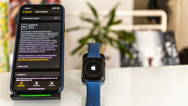 An Apple Watch sitting next to an iPhone displaying operating system upgrade info