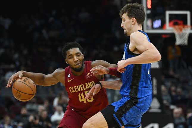 Dec 2, 2022; Cleveland, Ohio, USA; Orlando Magic forward Franz Wagner (22) defends Cleveland Cavaliers guard Donovan Mitchell (45) during the second half at Rocket Mortgage FieldHouse.