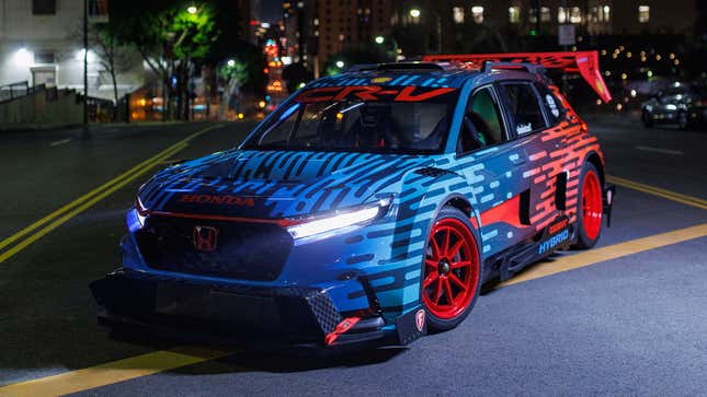 A photo of the front quarter of the CR-V race car with its lights on. 