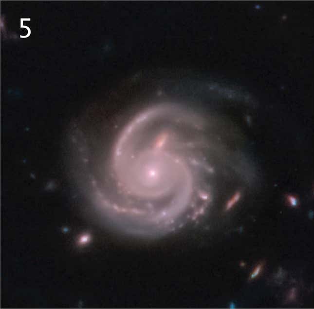  Una galaxia en espiral rosada.