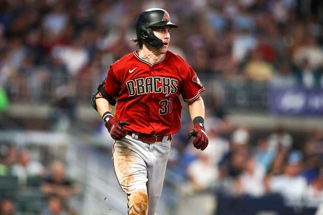 Jul 19, 2023; Atlanta, Georgia, USA; Arizona Diamondbacks right fielder Jake McCarthy (31) hits a single against the Atlanta Braves in the ninth inning at Truist Park.