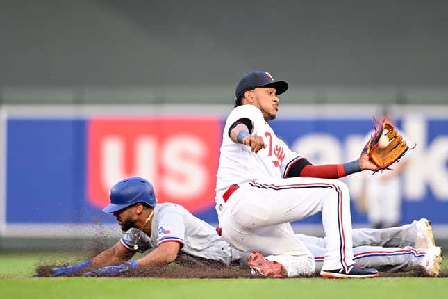 Aug 26, 2023; Minneapolis, Minnesota, USA; Texas Rangers center fielder Leody Taveras (3) slides in safe while stealing second base as Minnesota Twins second baseman Jorge Polanco (11) catches the ball to apply the tag during the fifth inning at Target Field.