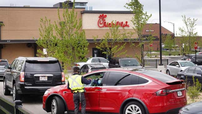 Chick-fil-A drive-thru lane with worker attending to customer