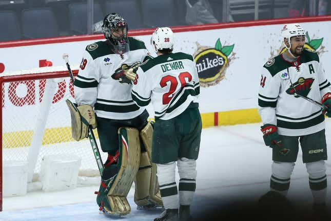 Mar 8, 2023; Winnipeg, Manitoba, CAN;  Minnesota Wild goalie Marc-Andre Fleury (29) is congratulated by his team mates on his win against the Winnipeg Jets at the end of the third period at Canada Life Centre.