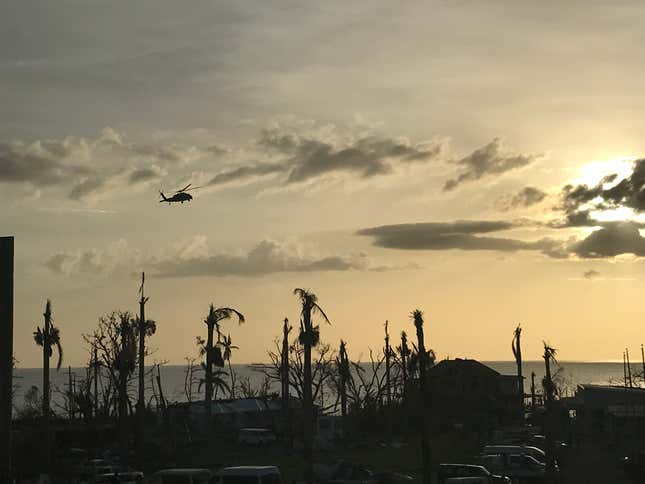 A US state department helicopter arrives to evacuate residents after Maria.