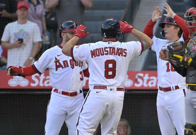 Jul 21, 2023; Anaheim, California, USA;   Los Angeles Angels first baseman Mike Moustakas (8) hit a three-run home run scoring left fielder Taylor Ward (3) and right fielder Mickey Moniak (16) in the fourth inning against the Pittsburgh Pirates at Angel Stadium.